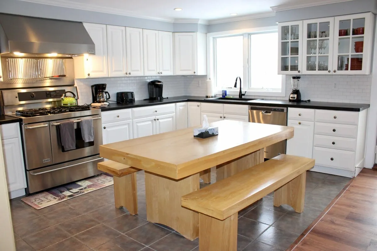 A spacious kitchen featuring a central island, sleek stainless steel appliances, and a large window that fills the space with natural light. The island provides ample room for meal preparation or gathering, and the modern appliances make cooking effortless. The overall layout encourages both cooking and socializing.